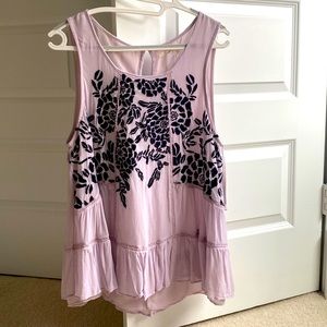 Airy purple top with embroidered dark purple flowers. Stylish summer look.